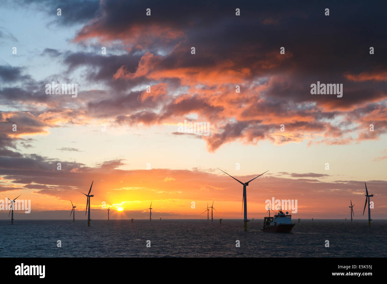 Sunset over the Gwynt y Mor Offshore Wind Farm off the coast of North Wales during the construction phase of spring 2014 Stock Photo