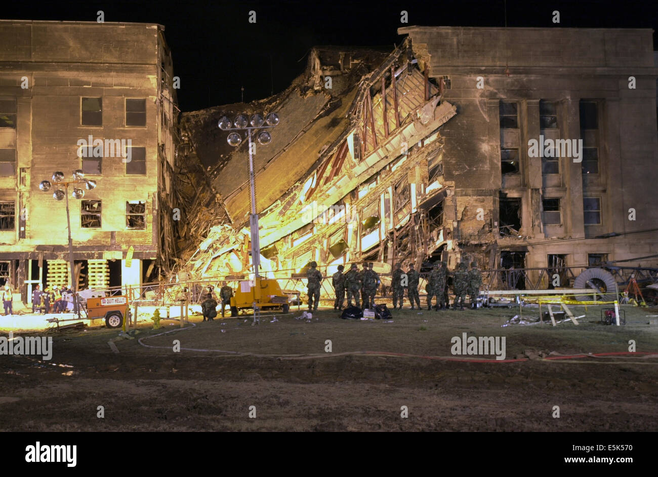 FEMA Urban Search and Rescue workers use a crane to clear rubble from