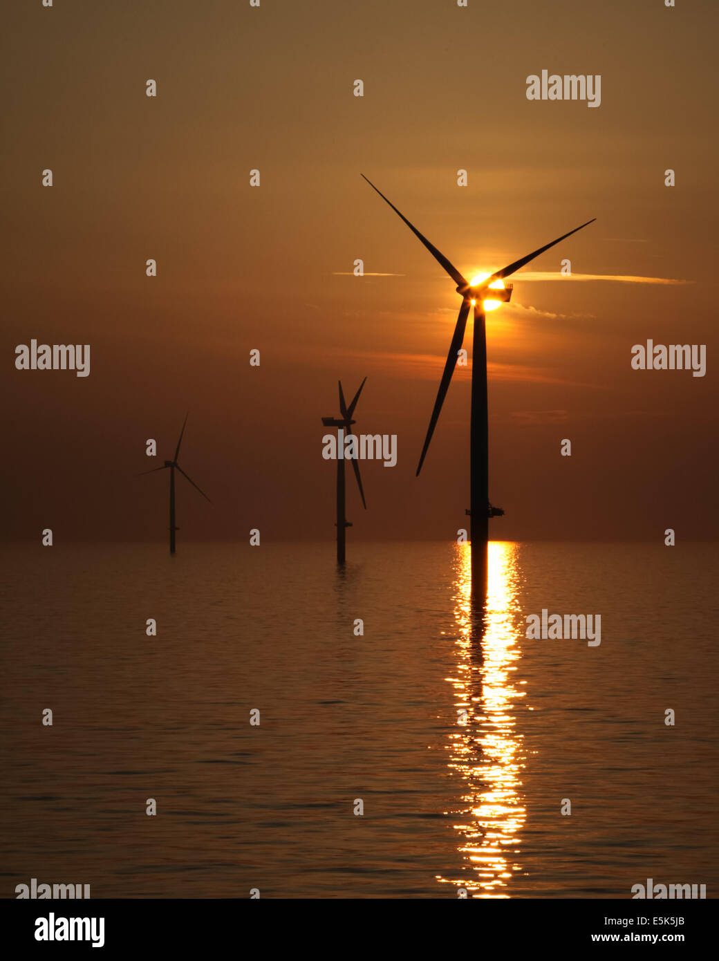 Sunset over the Gwynt y Mor Offshore Wind Farm off the coast of North Wales during the construction phase of spring 2014 Stock Photo