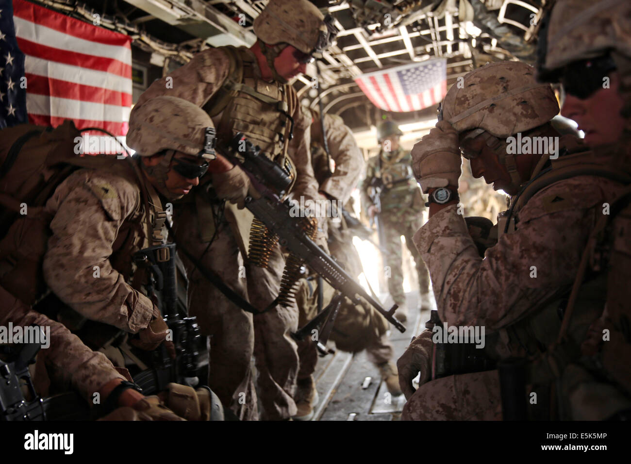 US Marines with the 1st Battalion, 7th Marine Regiment load onto a CH-53E Super Stallion helicopter after a three day mission July 6, 2014  in Gereshk,  Helmand province, Afghanistan. Stock Photo