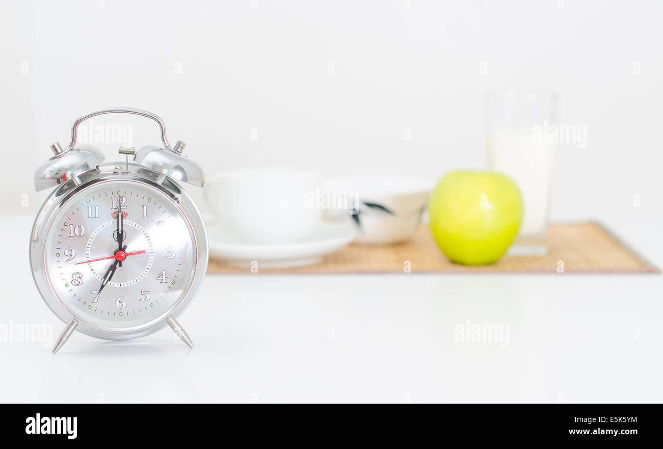 Alarm clock and breakfast on the background Stock Photo Alamy