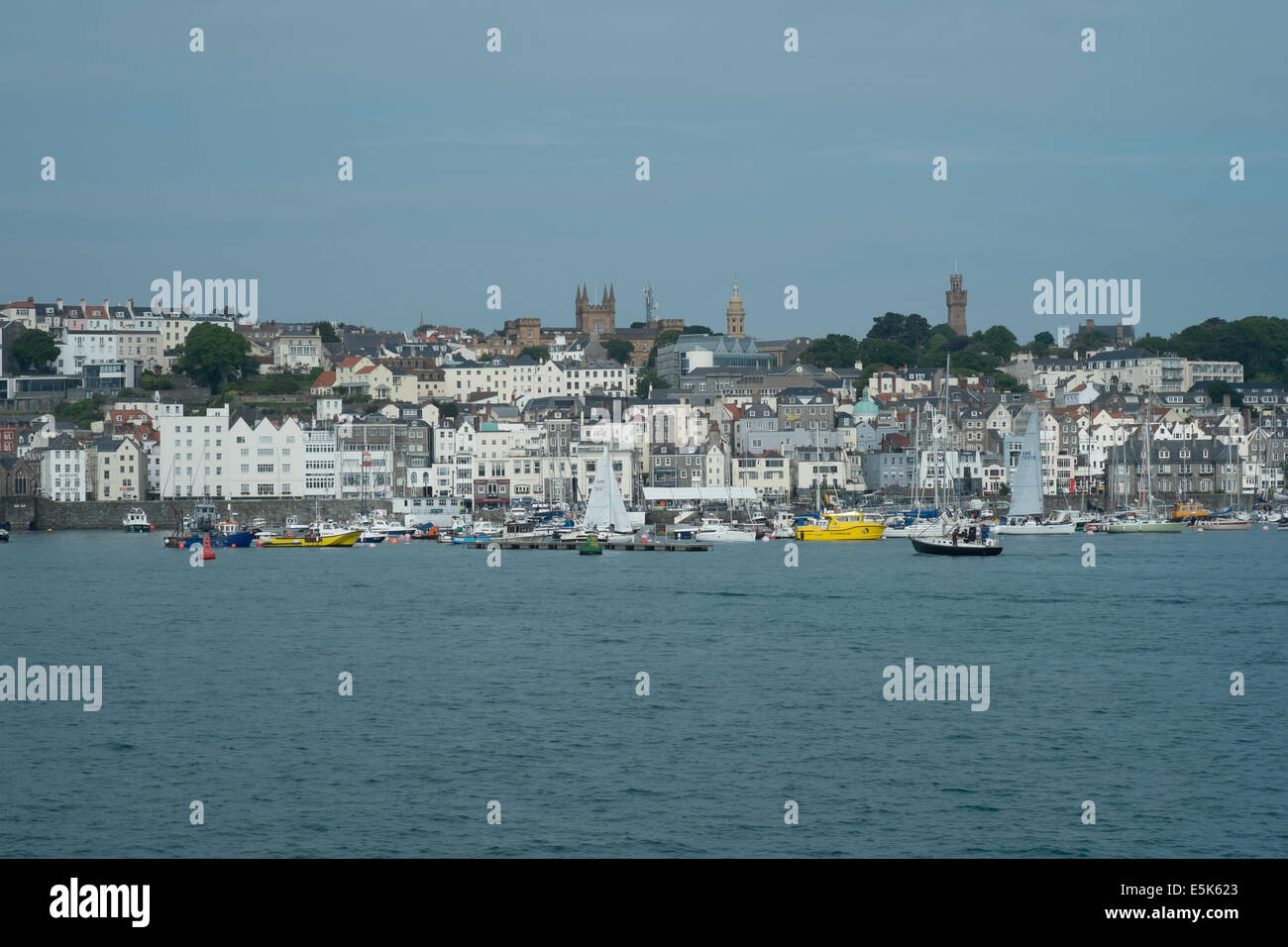 St Peter's Port harbour from the sea, showing various boats and the town in the distance, Guernsey, Channel islands Stock Photo