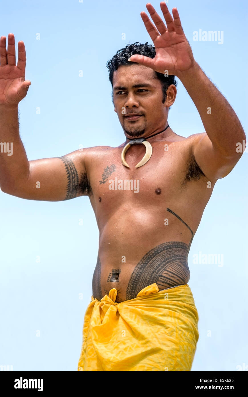 Male Polynesian dancer in traditional costume performing during a performance in Apia, Samoa. Stock Photo