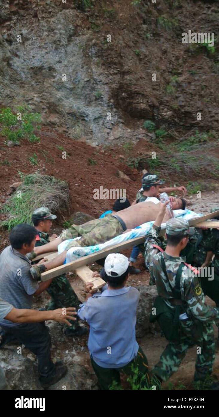 Zhaotong. 3rd Aug, 2014. This photo taken by cellphone on Aug. 3, 2014 shows rescuers evacuating an injured man after an earthquake in Ludian County of Zhaotong City in southwest China's Yunnan Province. A 6.5-magnitude earthquake jolted Ludian County at 4:30 p.m. Sunday (Beijing Time), said the China Earthquake Networks Center (CENC). By 8:00 p.m., more than 120 people are dead and over 180 are missing. Credit:  Xinhua/Alamy Live News Stock Photo