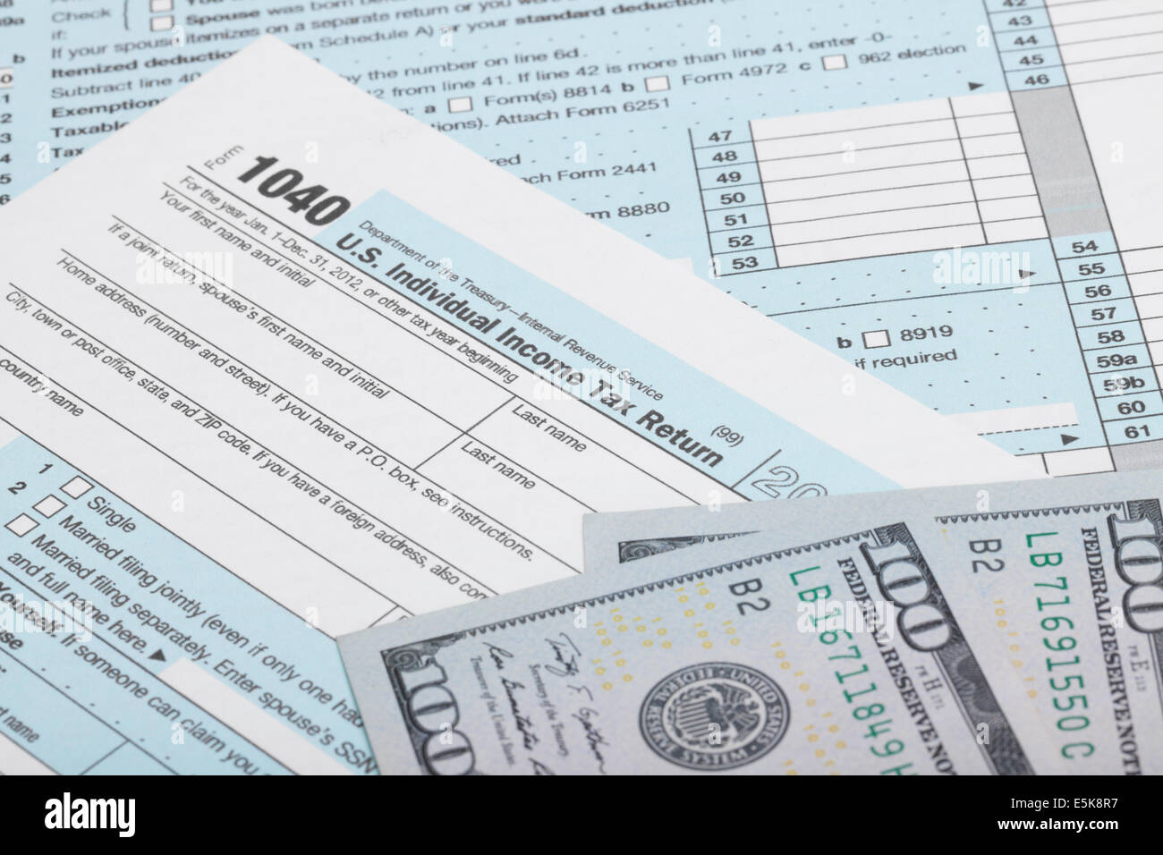USA 1040 Tax Form with two 100 US dollar bills over it Stock Photo - Alamy