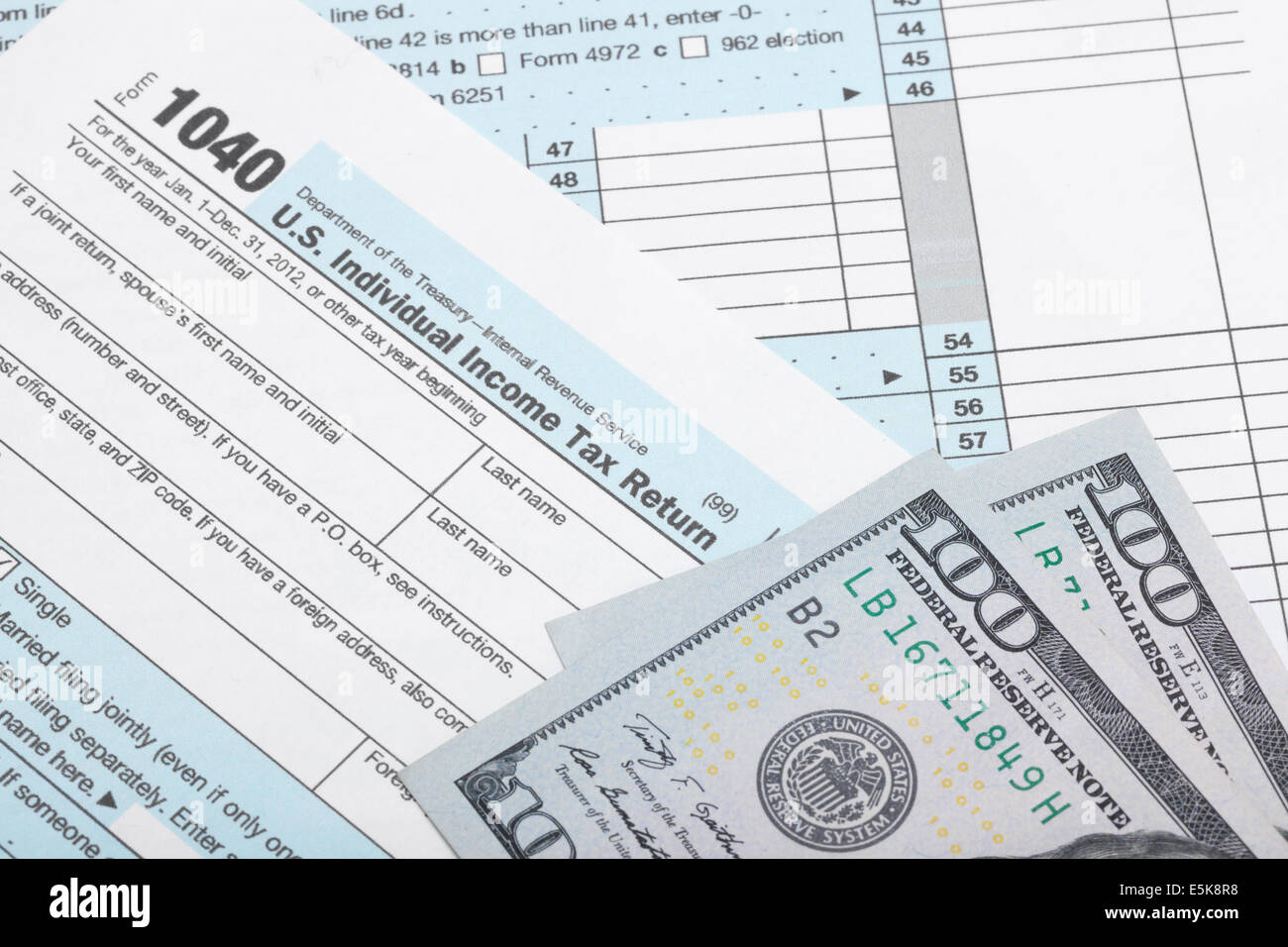 USA 1040 Tax Form with two 100 US dollar banknotes over it - studio ...