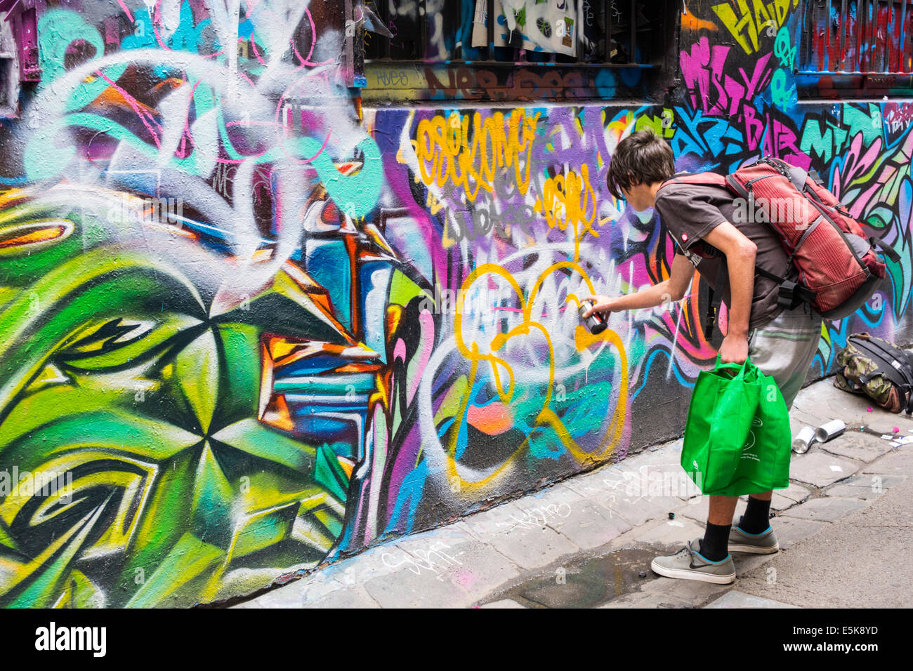Melbourne Australia,Hosier Lane,urban street art,murals,graffiti,teen teens teenager teenagers boy boys,male kid kids child children youngster youngst Stock Photo