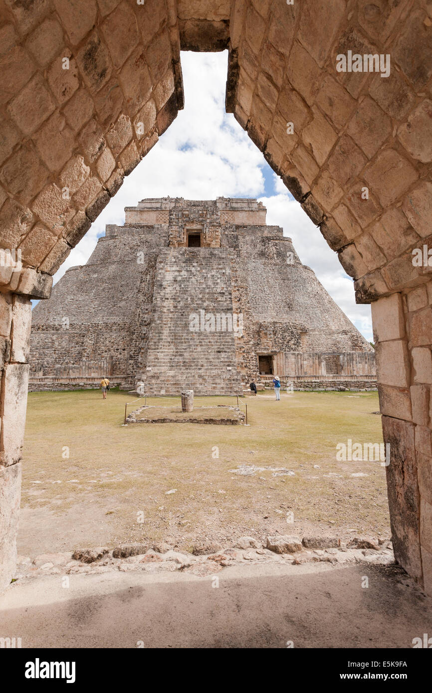 Rear view of the Magician's Pyramid through an arch. Steep stairs lead up to the ceremonial temple chambers high in the pyramid Stock Photo
