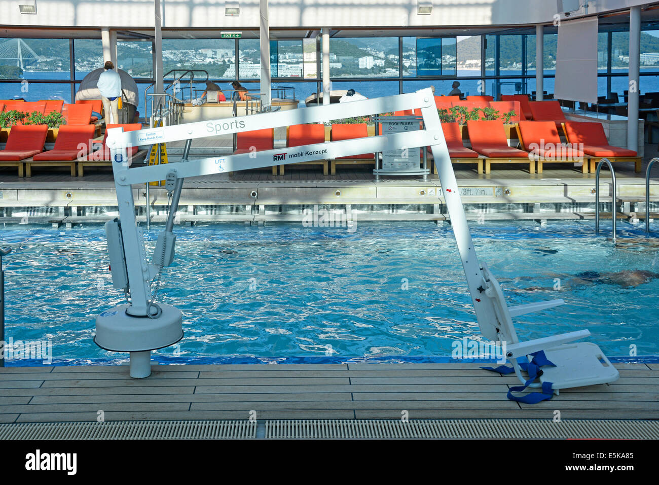 Hoist to assist people with disabilities to enter and leave the water in a cruise ship indoor swimming pool (ship in port Europe) Stock Photo