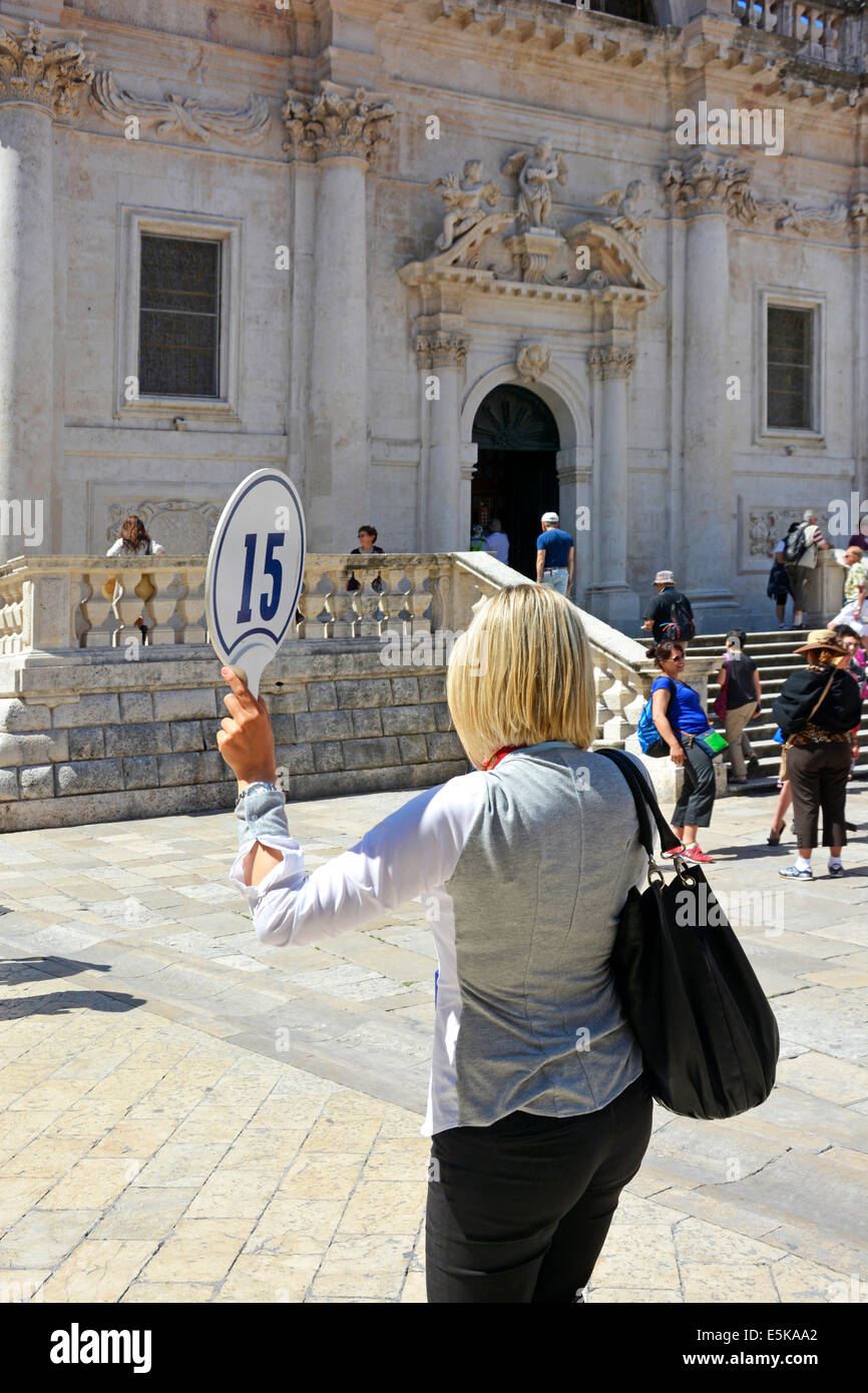 Tourist guide holds up cruise tour number flag board outside the church of St Vlaho (Saint Blaise) Luza Square Dubrovnik Croatia Dalmatia Adriatic Stock Photo