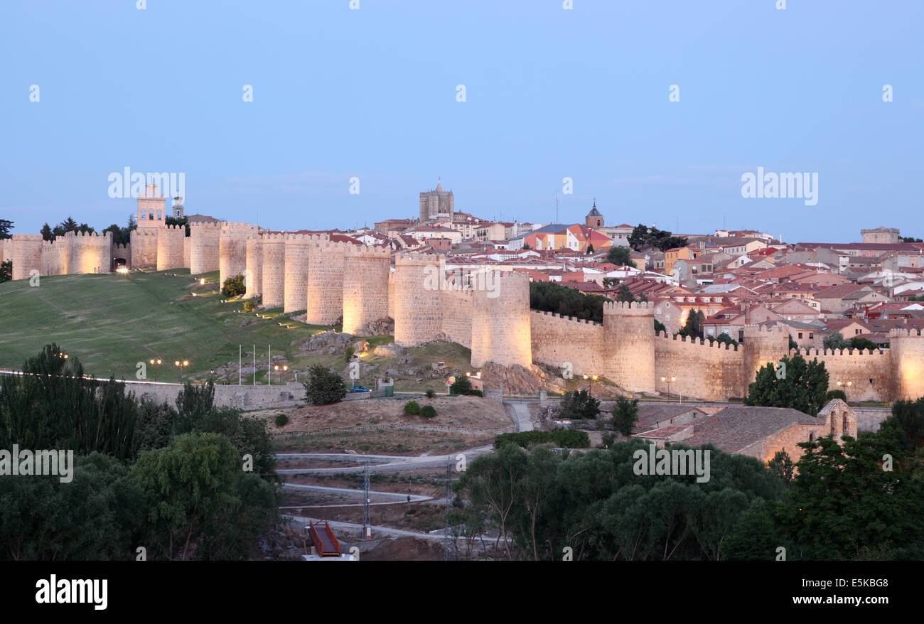 Medieval city walls of Avila illuminated at dusk. Castile and Leon, Spain Stock Photo