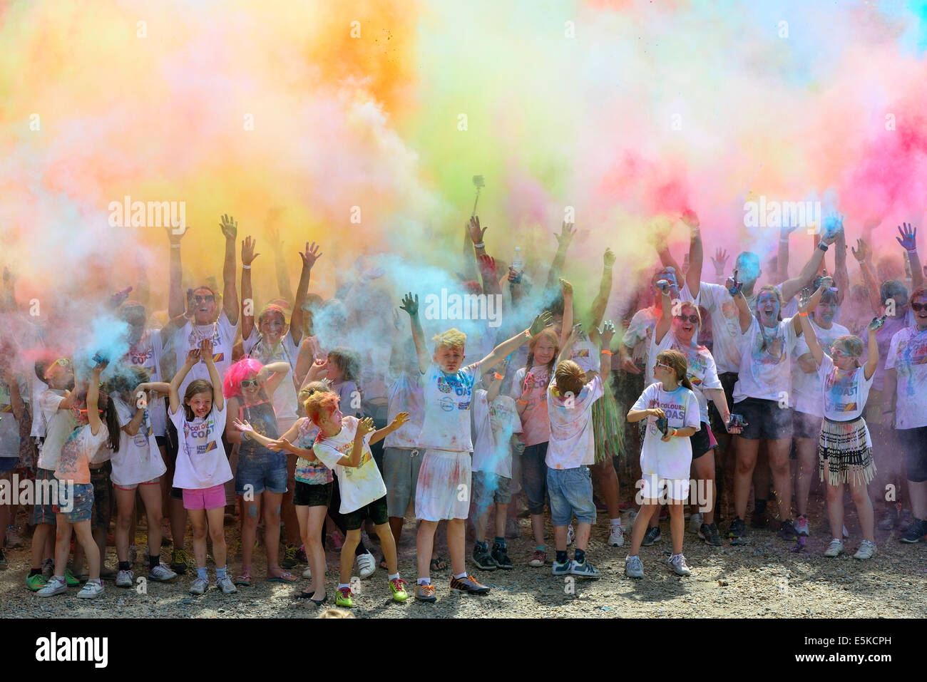Hastings. East Sussex. UK. 3rd August 2014. Participants in The Colour The Coast fun run along the seafront of the old town. Runners along the 4K course had to pass through four colour zones where willing helpers known as ‘Cherry Chuckers’ showered runners with a coloured dye before a finish line party extravaganza involving everyone throwing powder into the sky to create a colour cloud. This was a fundraising event for St Michael’s Hospice in St Leonards on Sea. Credit:  Parkerphotography / Alamy Live News Stock Photo