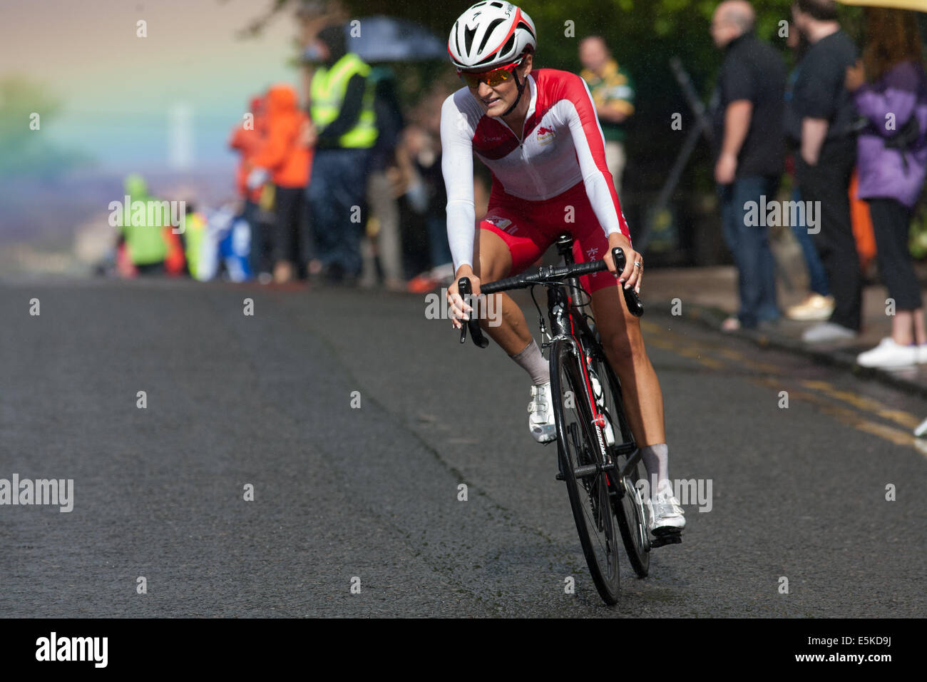 GLASGOW, UK, Scotland, 3rd August, 2014.  Lizzie Armitstead with a rainbow behind her on her way to a gold medal at the Commonwealth Games Ladies Cycling Road Race. Credit:  Ian McFarlane/Alamy Live News Stock Photo