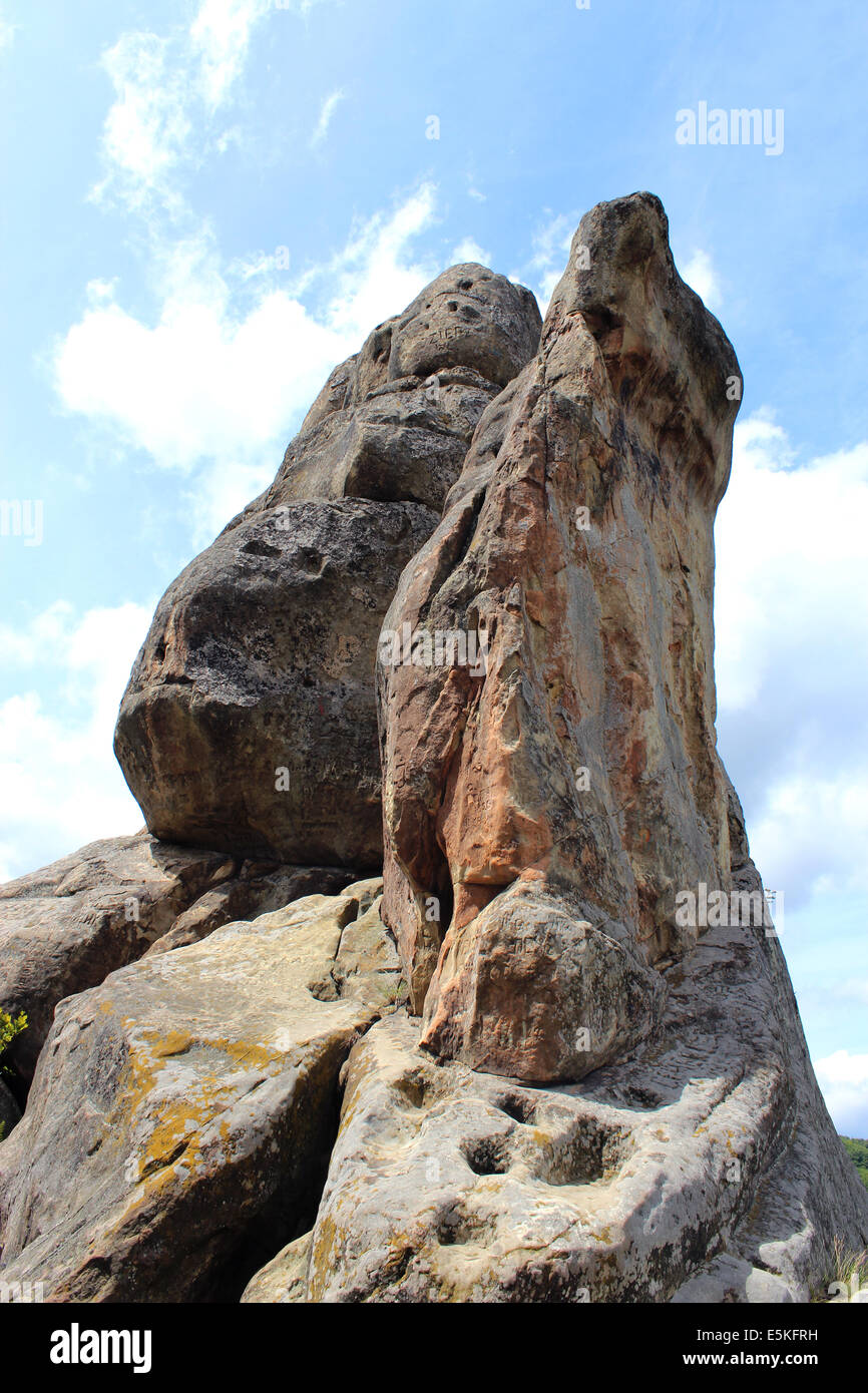 big stone rock on the white clouds background Stock Photo