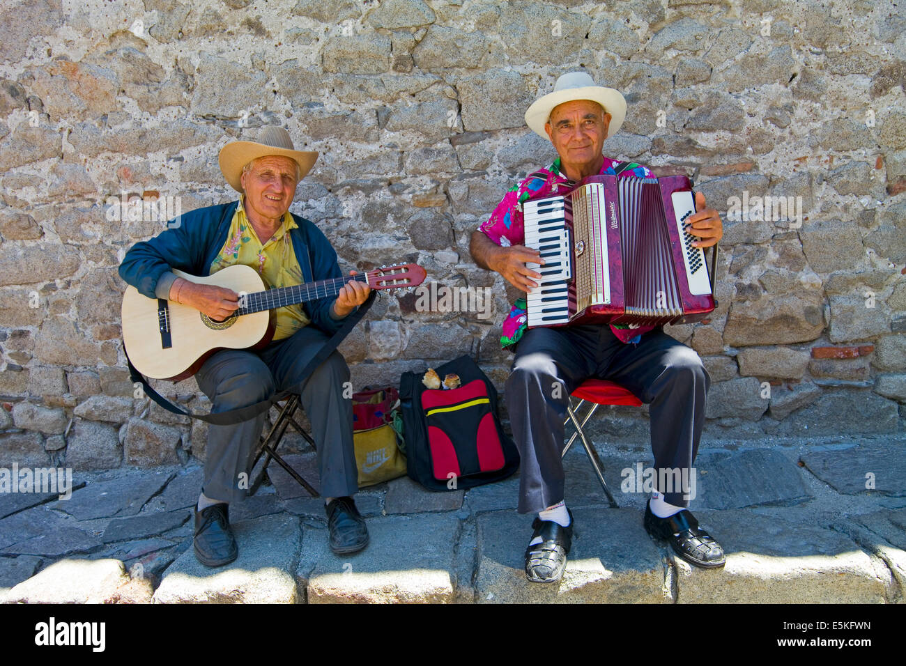 In formal portrait of two street musicians playing a guitar and an accordion in Plovdiv, Bulgaria Stock Photo