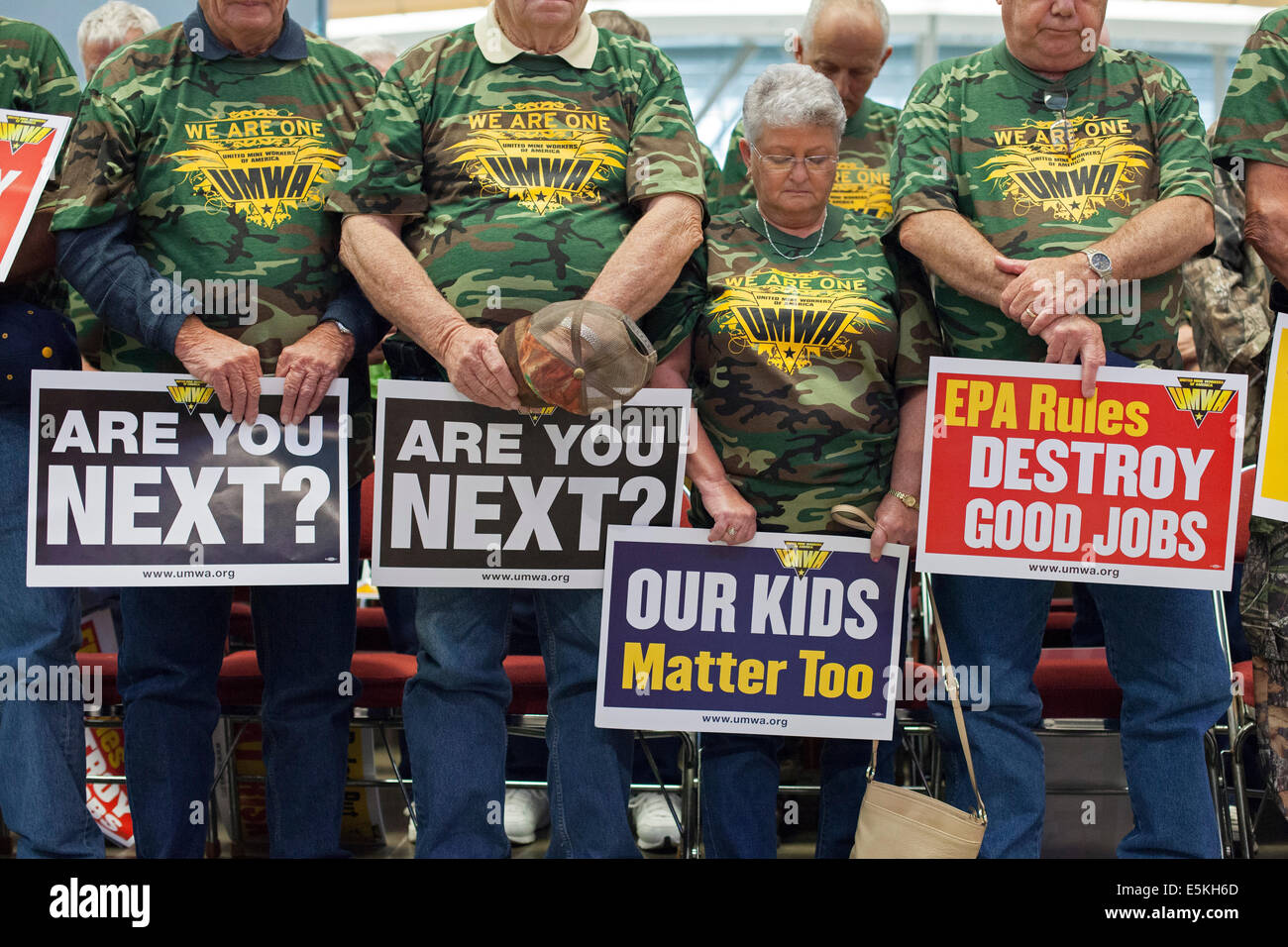 Pittsburgh, Pennsylvania - Members of the United Mine Workers of America pray during a rally against coal-burning restrictions. Stock Photo