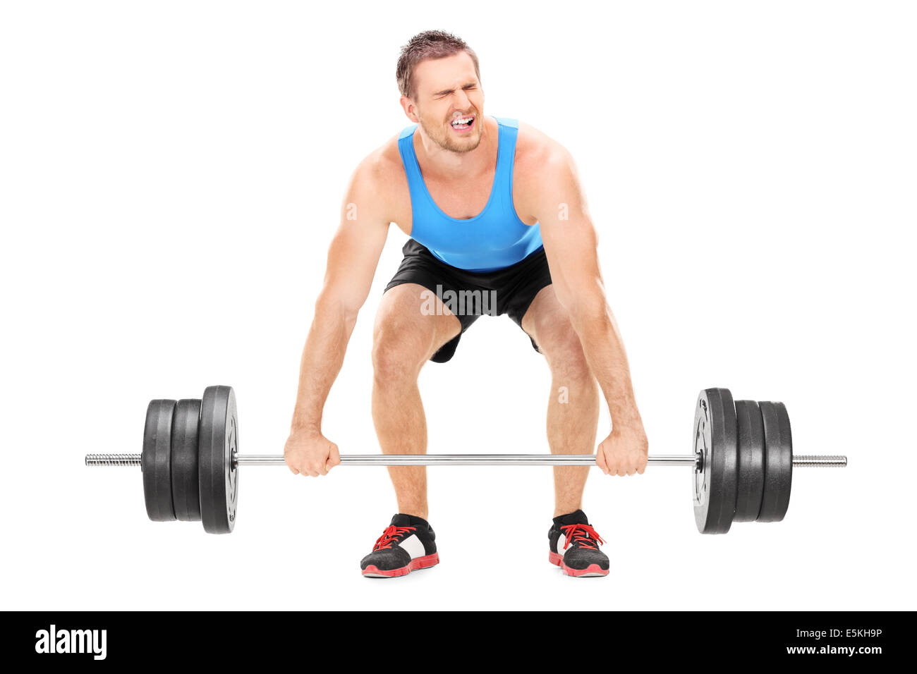 Bodybuilder struggling to lift a barbell Stock Photo
