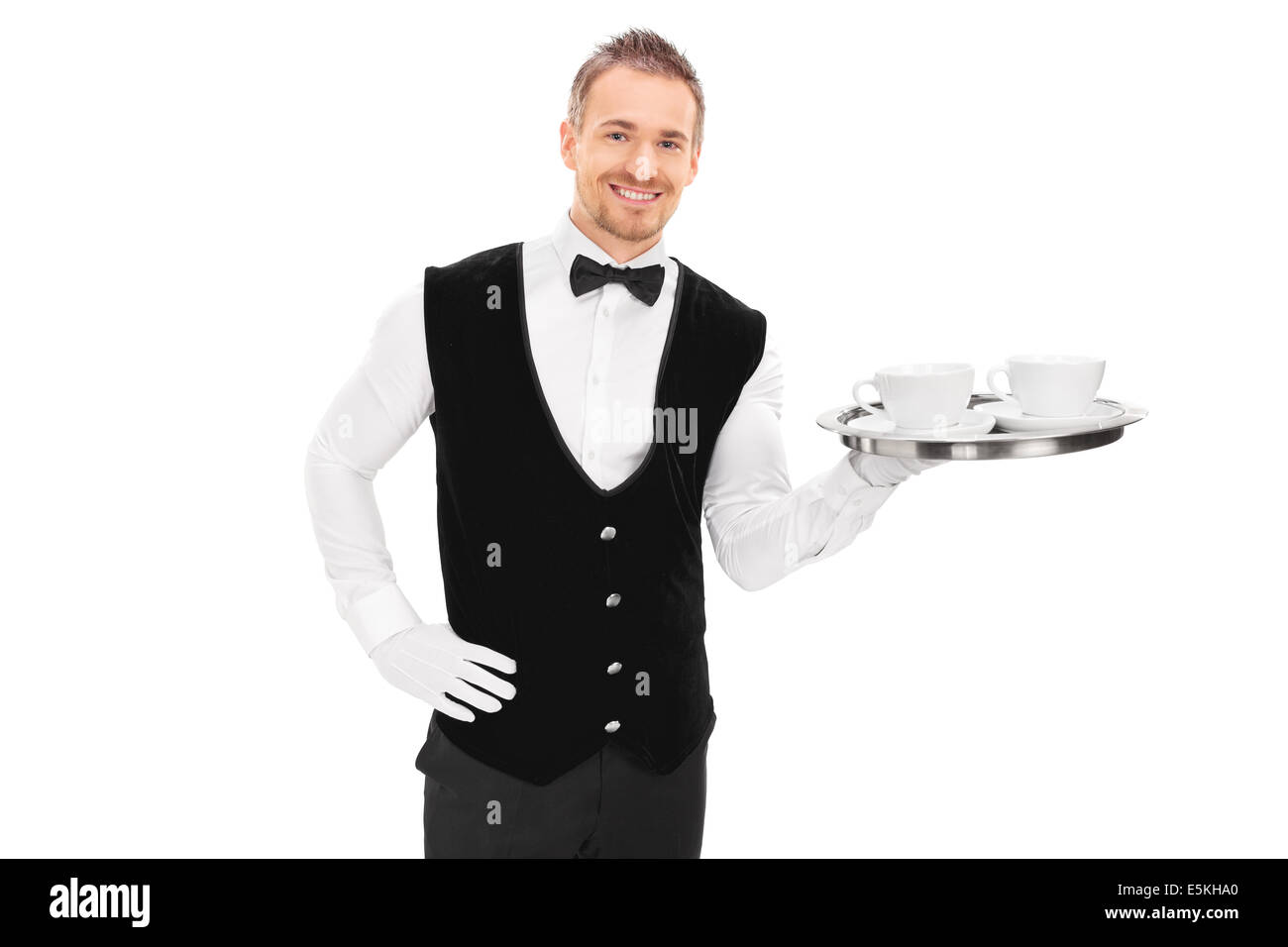 Male butler holding a tray with two cups of coffee Stock Photo