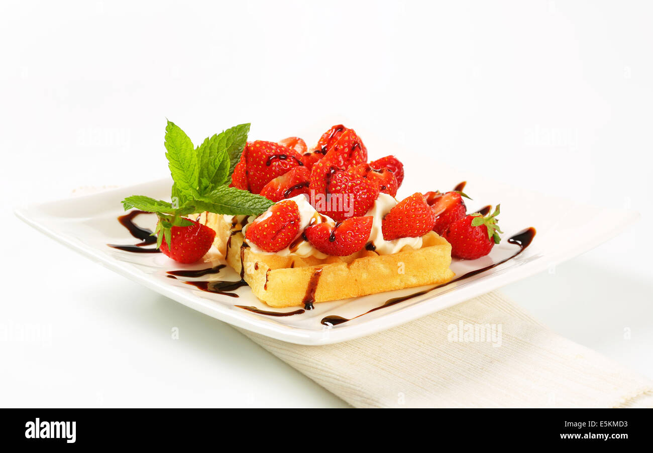 Belgian waffle with whipped cream and fresh strawberries Stock Photo ...