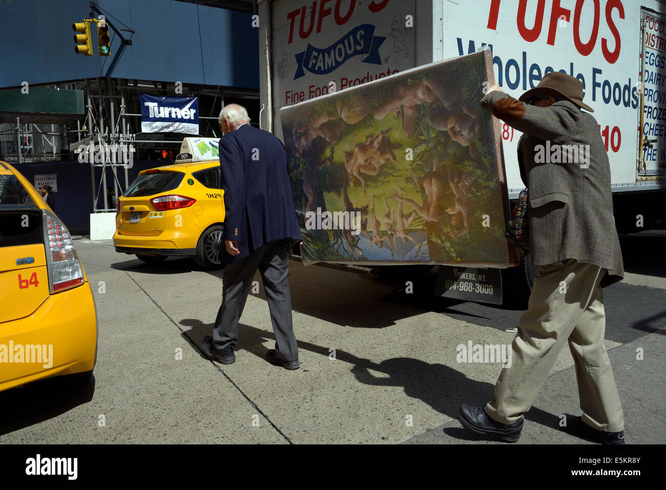 new york manhattan men carry painting Stock Photo