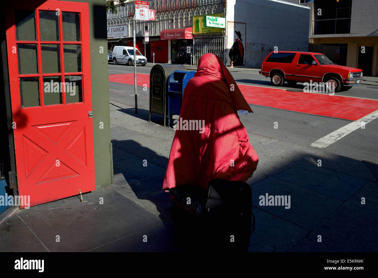 man in red walks street corner san francisco Stock Photo