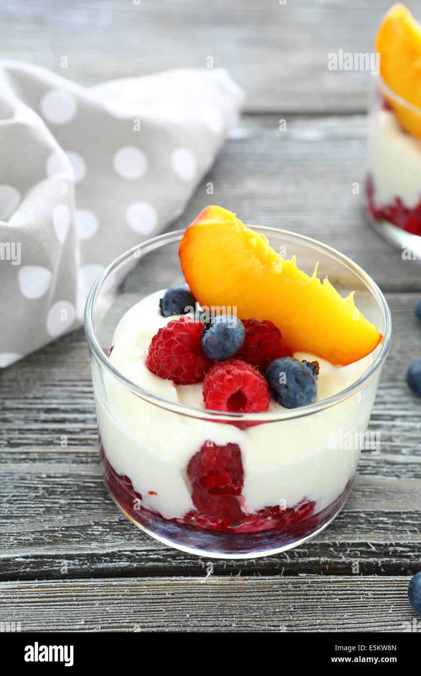 fresh yogurt with peach and berries, food closeup Stock Photo