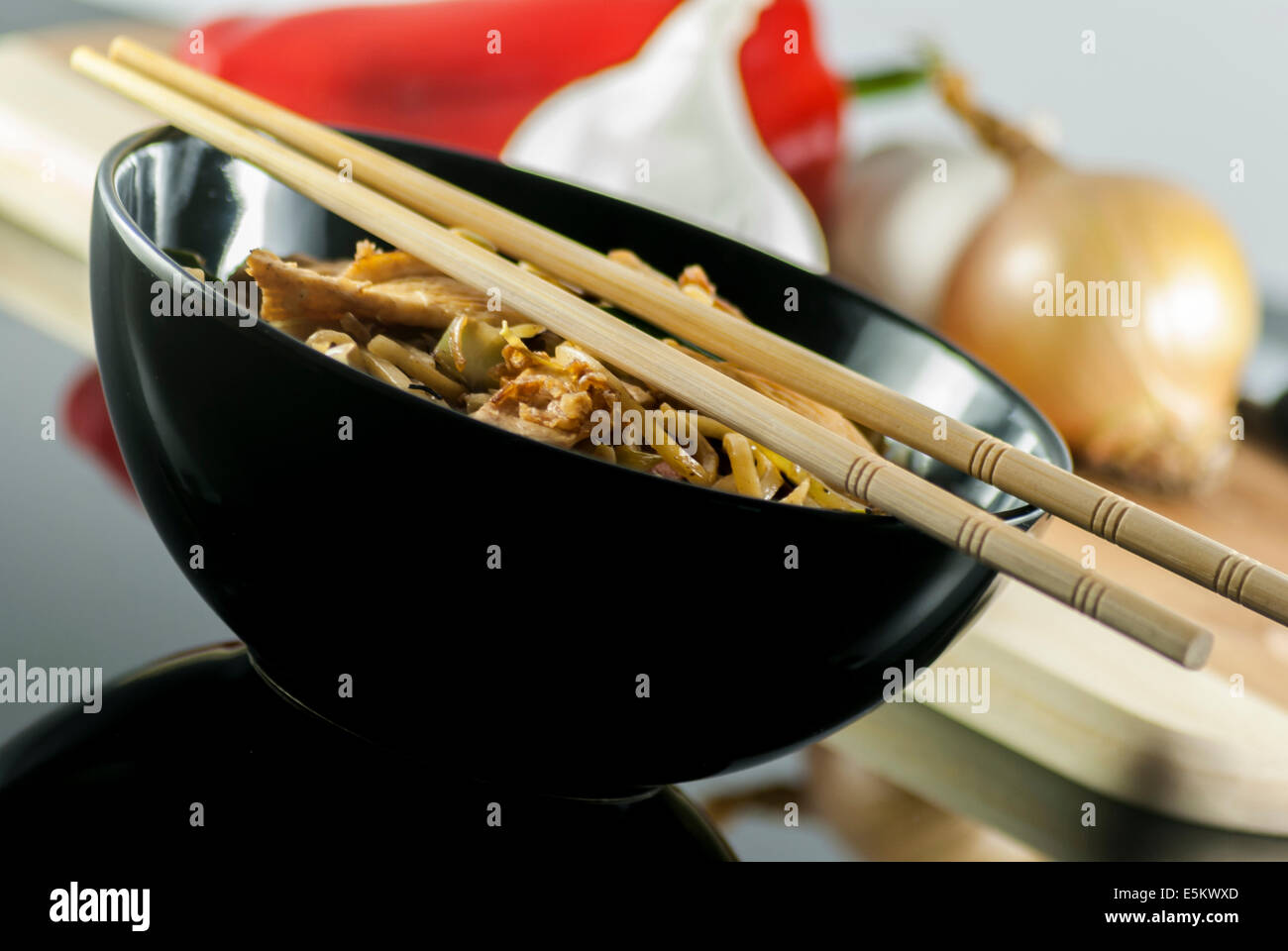 chinese noodle with chicken and vegetables on reflect table Stock Photo