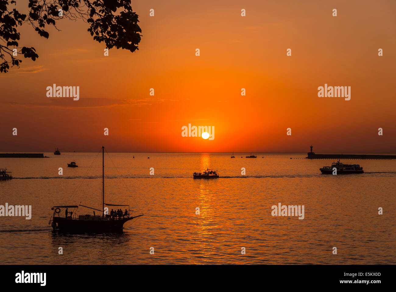 Bright sunset, quiet bay, walk on a yacht at sunset Stock Photo