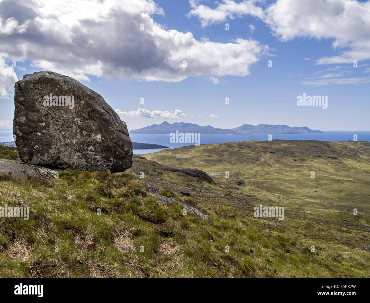Massive boulder high on the slopes of Sron na Ciche with Isle of Rum beyond, Glenbrittle, Isle of Skye, Scotland, UK Stock Photo