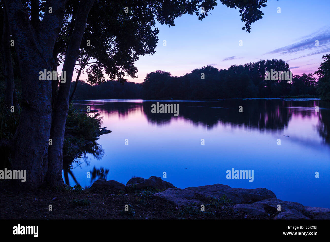 Twilight over a small lake in Swindon, Wiltshire. Stock Photo