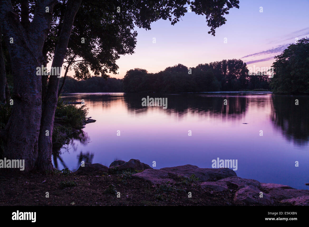 Twilight over a small lake in Swindon, Wiltshire. Stock Photo