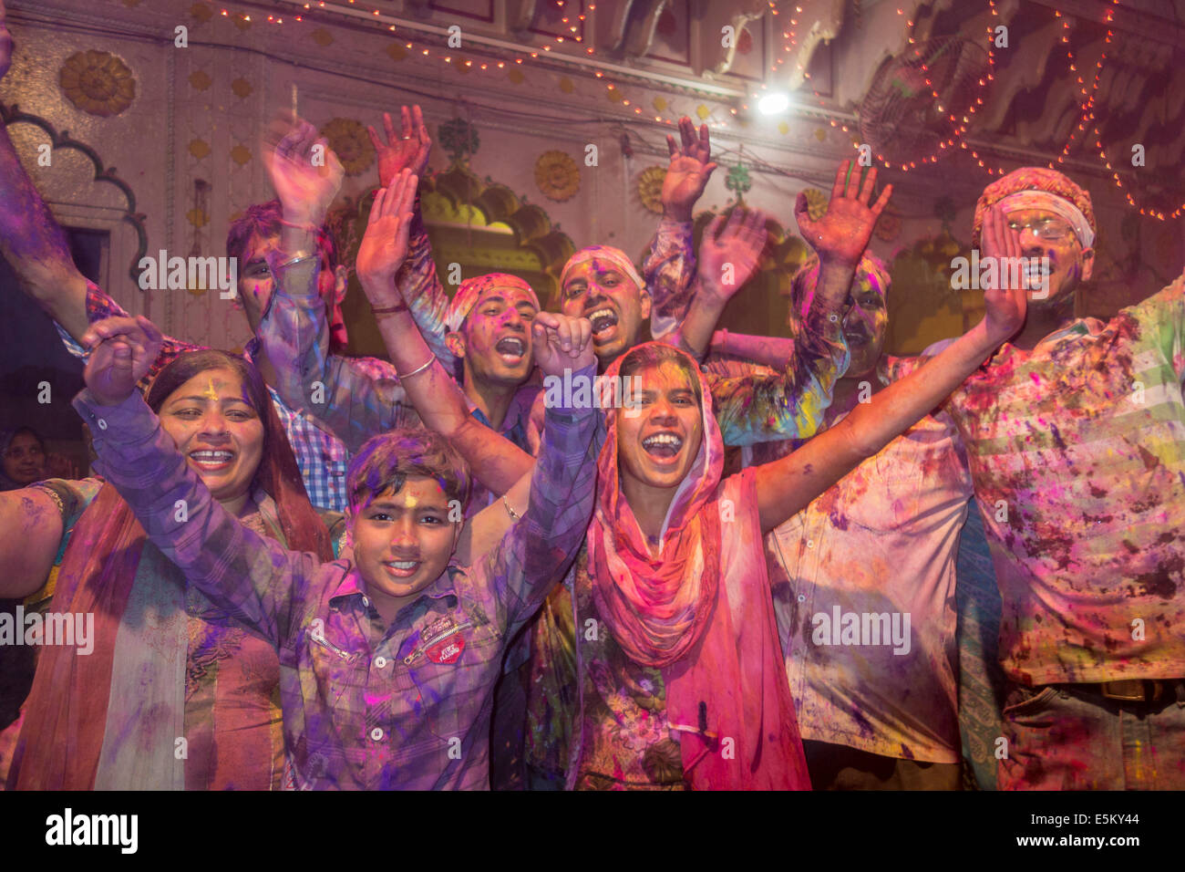 Devotees covered in coloured powder celebrating, Holi festival, Banke Bihari Temple, Vrindavan, Uttar Pradesh, India Stock Photo