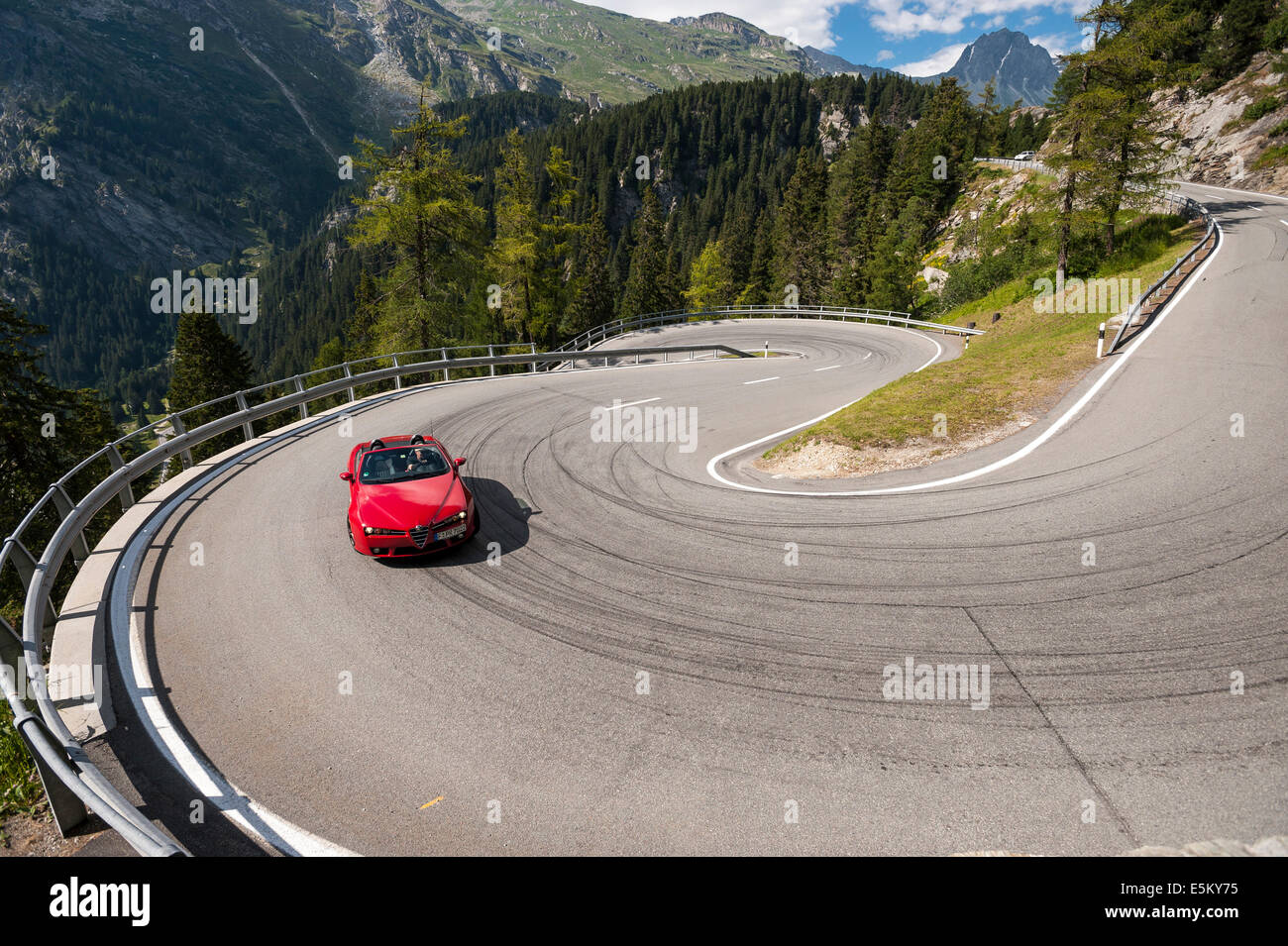 Red convertible travelling on the Maloja Pass, serpentines, winding road, near Sondrio, Lombardy, Italy Stock Photo