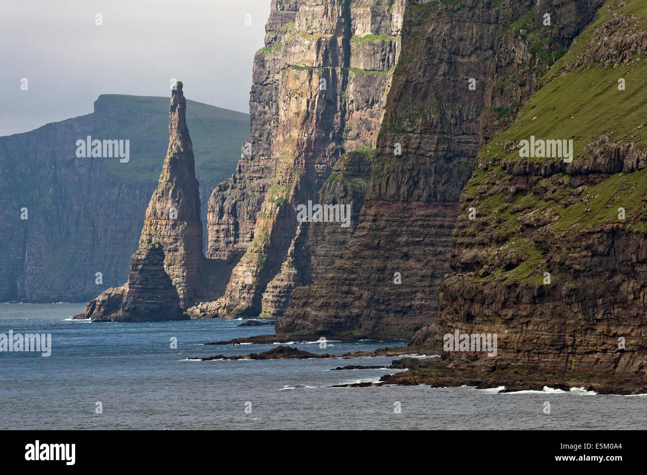 Rock pinnacle and cliff, west coast of Sandoy, Faroe Islands, Denmark Stock Photo