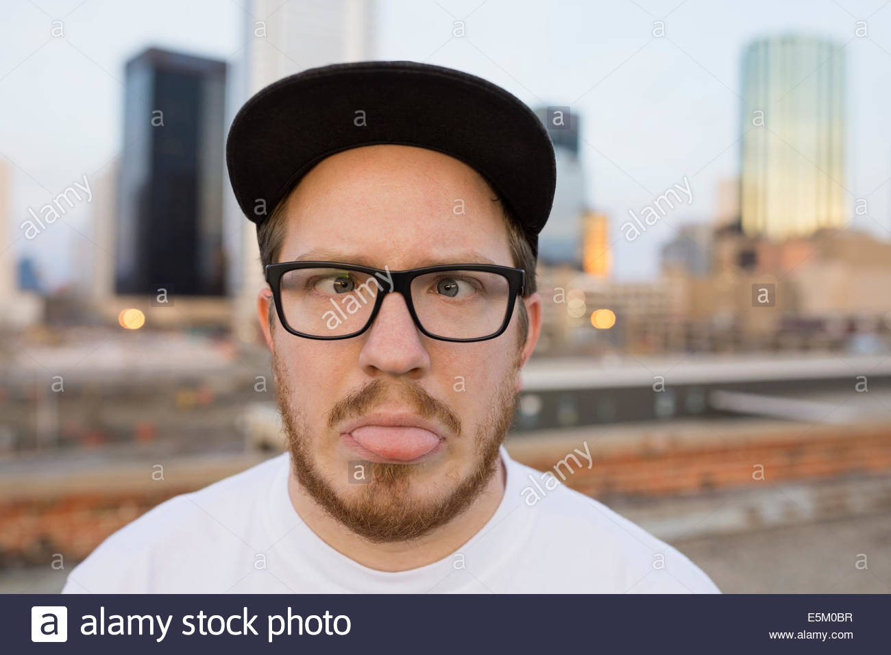 Portrait of man making a face on urban rooftop Stock Photo