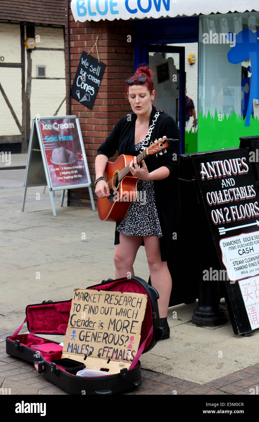 Female busker playing guitar hi-res stock photography and images - Alamy