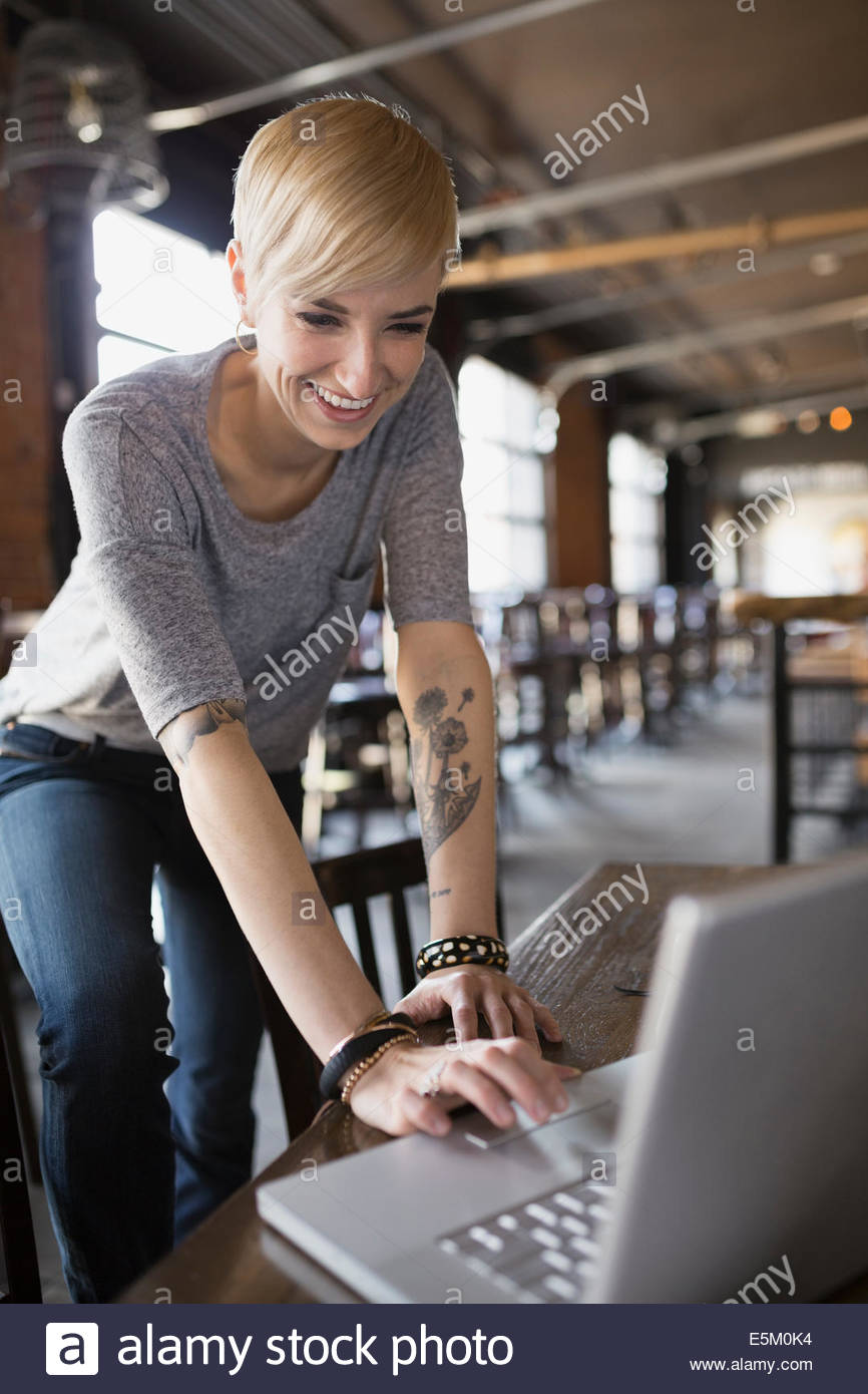 Pub owner working on laptop Stock Photo