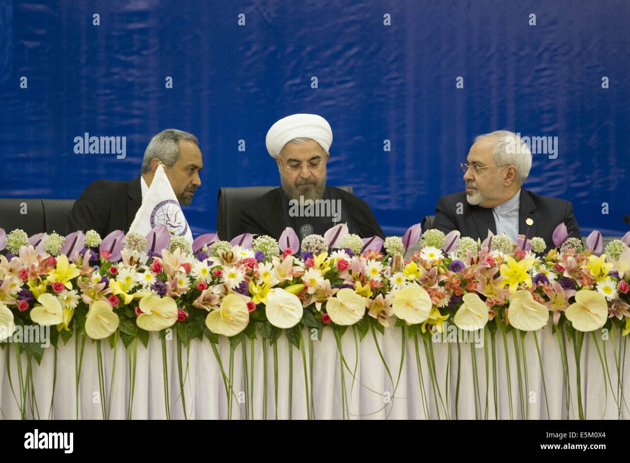 Tehran, Iran. 4th Aug, 2014. Chief of Staff of the President of Iran, MOHAMMAD NAHAVANDIAN (L), speaks with Iran's Foreign Minister MOHAMMAD JAVAD ZARIF (R) as they and Iranian President HASSAN ROUHANI attend the opening of Non-Aligned Movement Ministerial Committee on Palestine Meeting on Situation in Gaza, in Tehran. Morteza Nikoubazl/ZUMAPRESS Credit:  Morteza Nikoubazl/ZUMA Wire/Alamy Live News Stock Photo