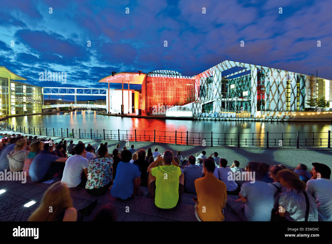 Germany, Berlin: Tourists watching nocturnal video documentary about the history of the Reichstag  at Spree riverside Stock Photo