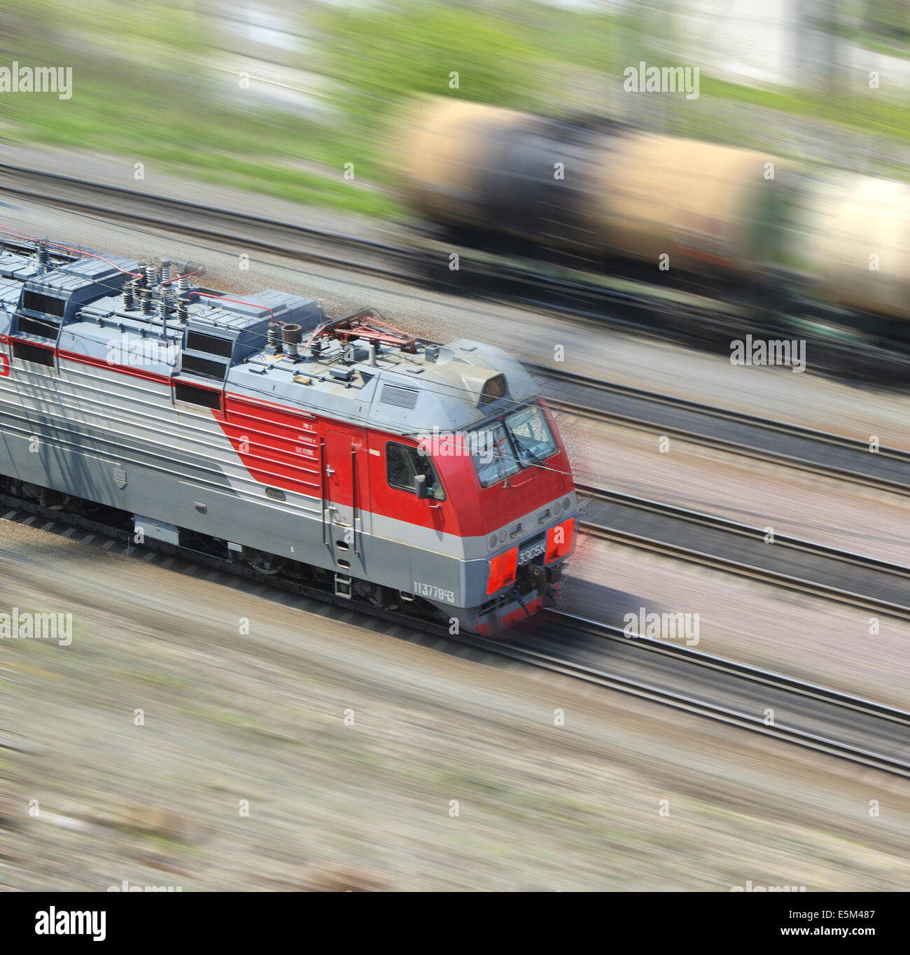 train in motion on the background of railway wagons Stock Photo