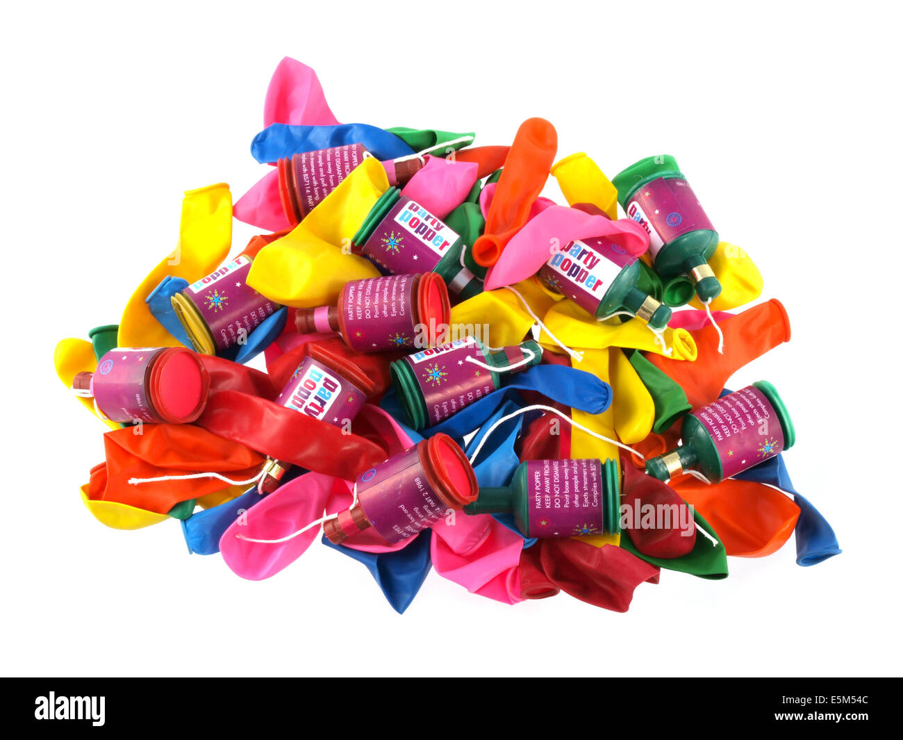 Close up of balloons and party poppers on a white background. Stock Photo