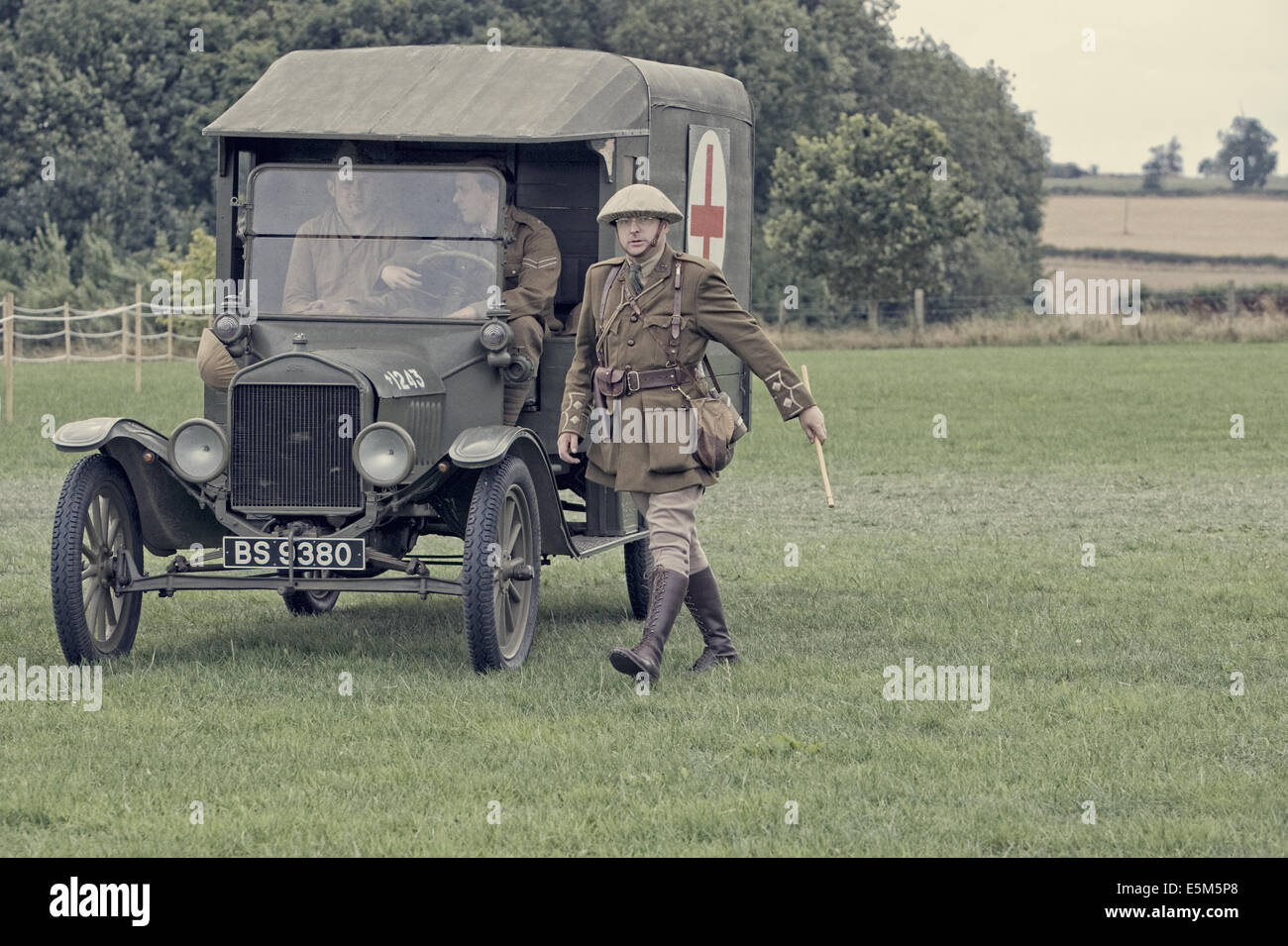 Ford 1916 Model T Field Ambulance used in First World War by Allied Expeditionary Forces with Lieutenant in Brodie Helmet walking Stock Photo