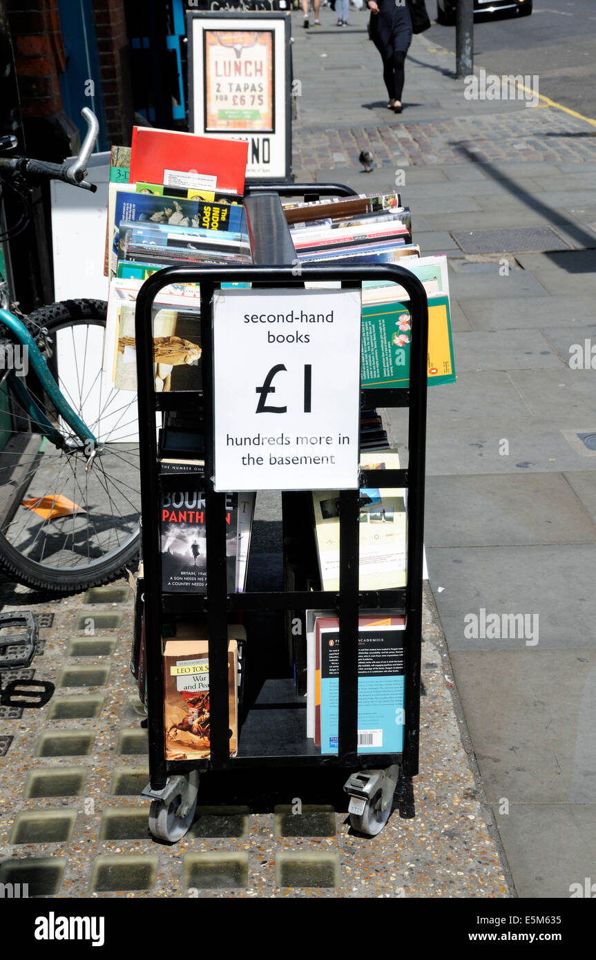 Second-hand books for sale £1 from bookcase in street outside Housmans Bookshop Caledonian Road Islington London England UK Stock Photo