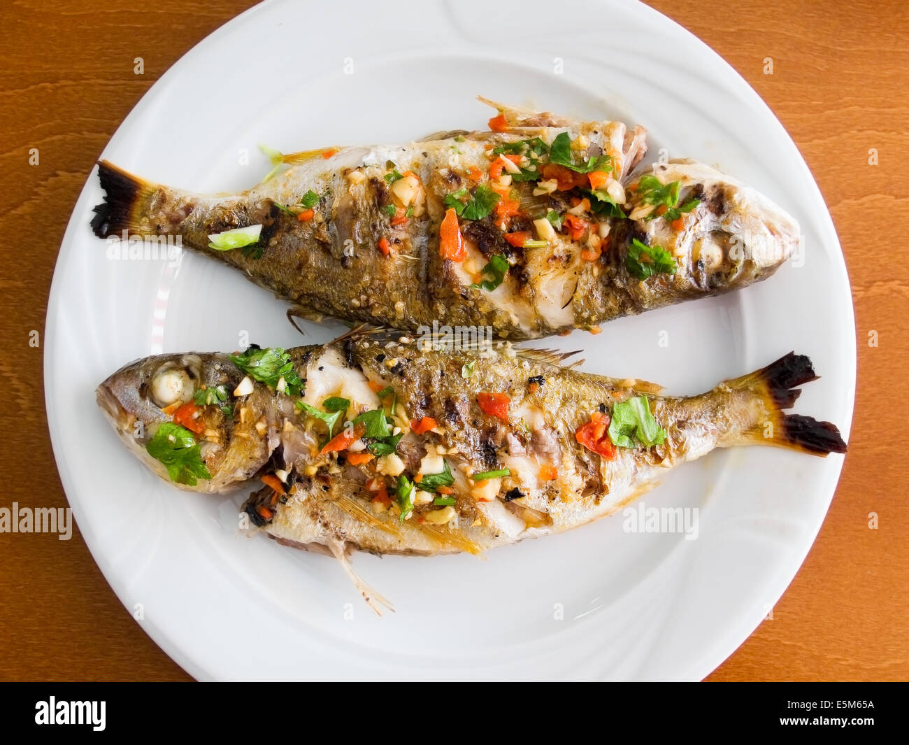 Breams grilled with seasoning. Typical mediterranean dish. Stock Photo
