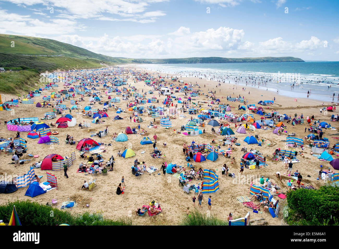 Windbreaks line the beach as thousands of sunbathers enjoy the summer