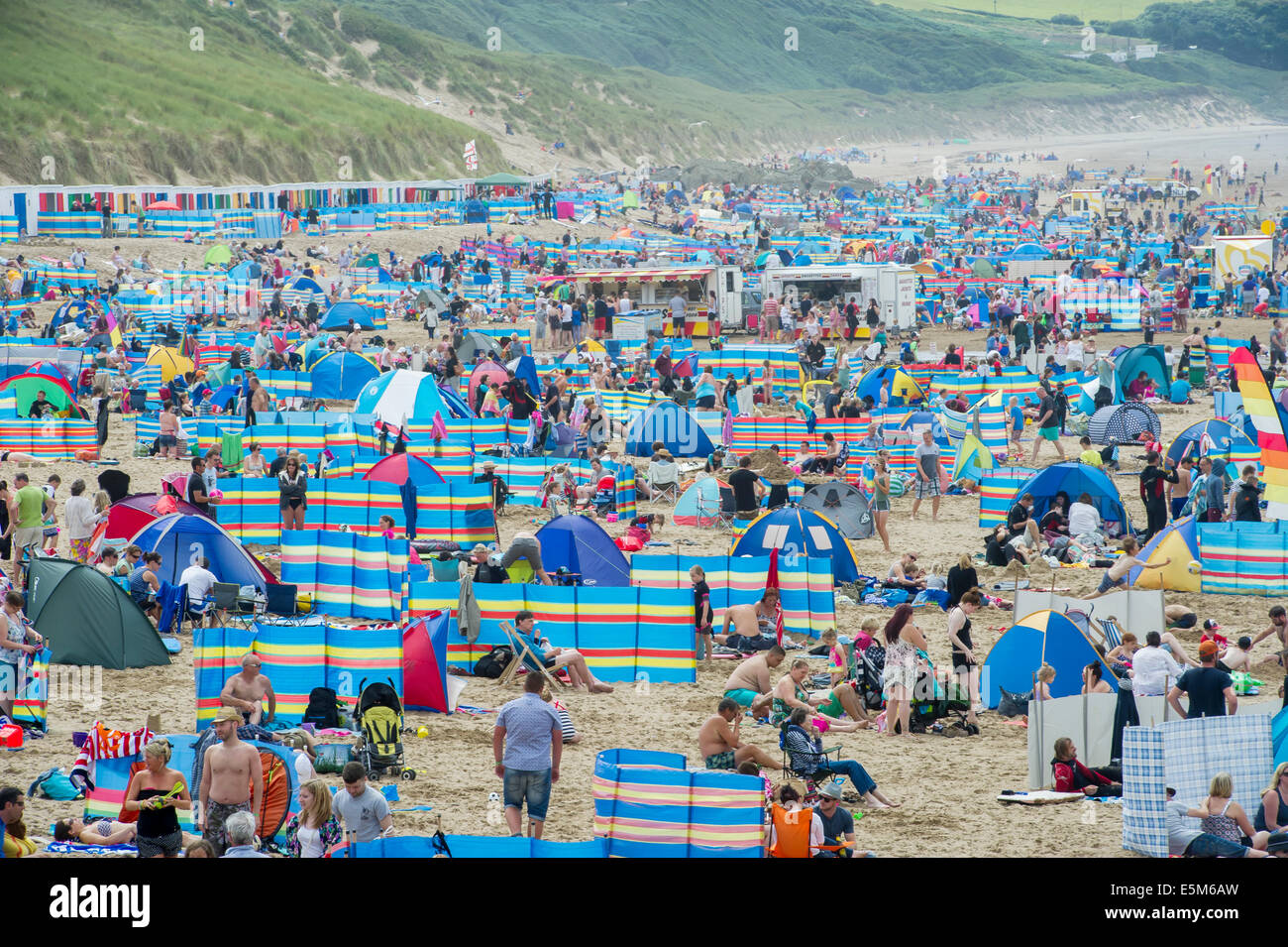 Windbreaks line the beach as thousands of sunbathers enjoy the ...