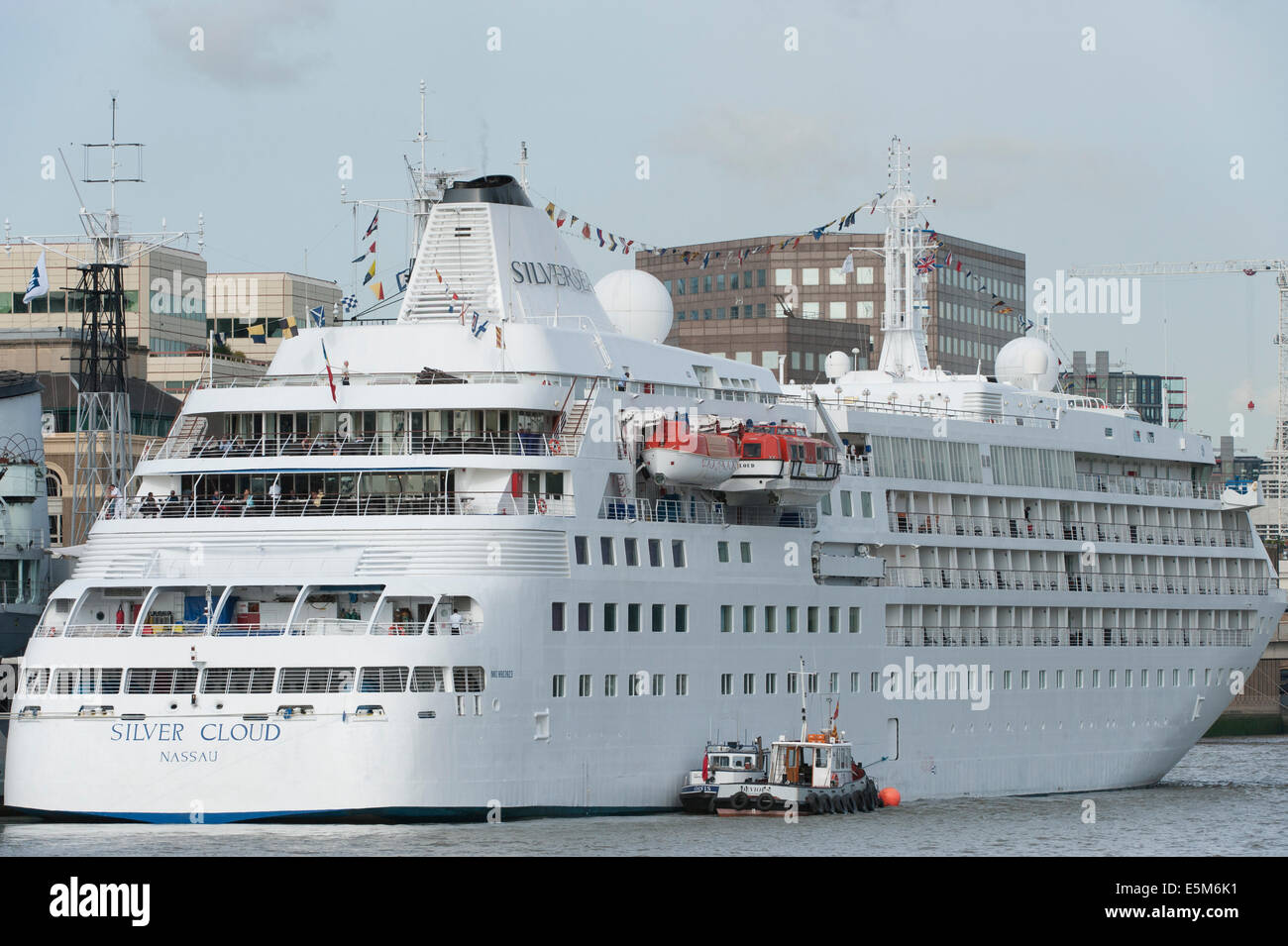 London, Tower Bridge, UK. 4th August 2014. M.V. Silver Cloud cruise ship moored alongside HMS Belfast leaves London today to Reykjavik, Iceland. Credit:  Malcolm Park editorial/Alamy Live News Stock Photo