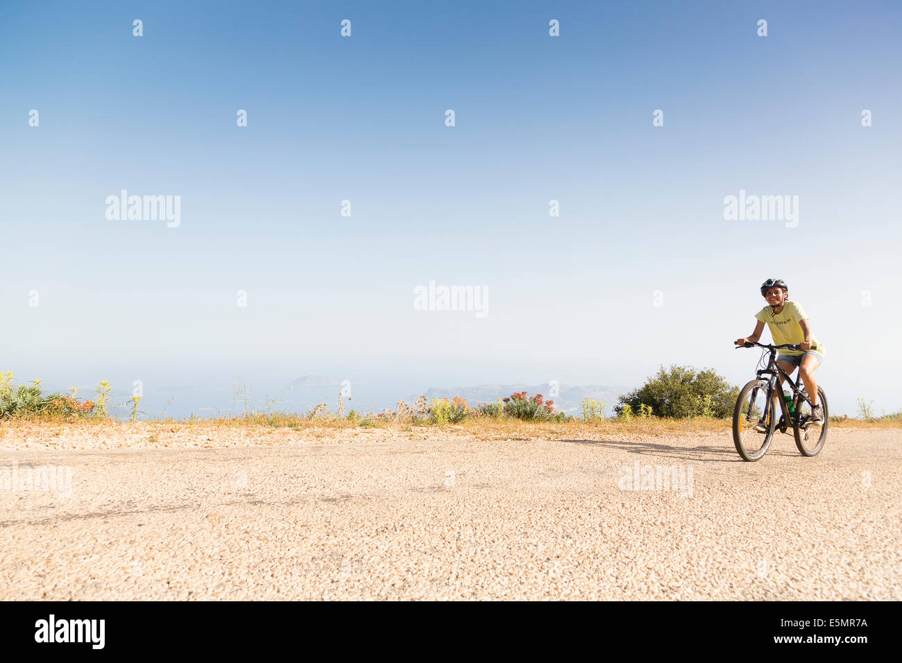 KAS, TURKEY Smiling Exodus cycling client climbing hill. Stock Photo