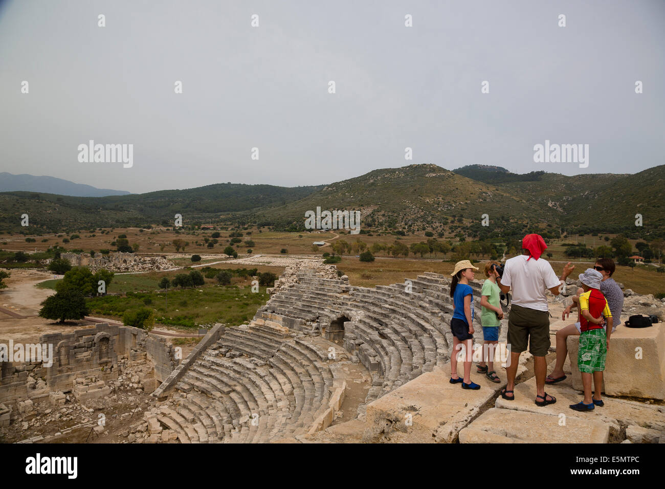 PATARA BEACH, TURKEY Young Exodus clients with guide Maho Arican at Lycian ruins. Stock Photo