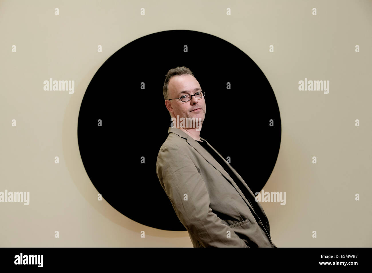 Artist, Alan Begg with his sculpture, 23.5*(degrees), on show at the SSA exhibition at the Royal Scottish Academy, Edinburgh Stock Photo